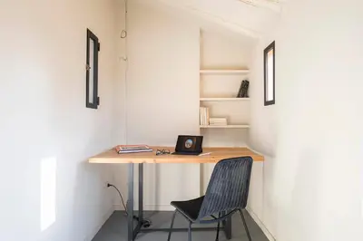 a room with a desk with a chair and a laptop at Colosseo Esclusivo attico con terrazze private in Rome