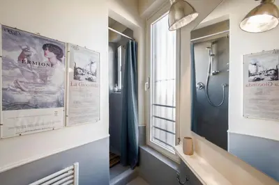 a bathroom with a shower and a window at Colosseo Esclusivo attico con terrazze private in Rome