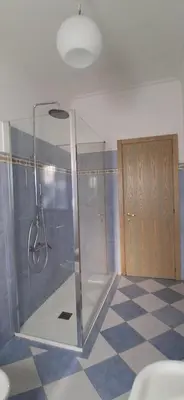 a bathroom with a shower and a checkered floor at Family Suite in Rome