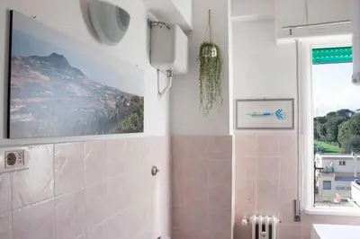 a bathroom with a shower with a television on the wall at Mickey's House in Rome