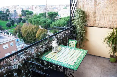 a balcony with a table and a view of a city at Mickey's House in Rome