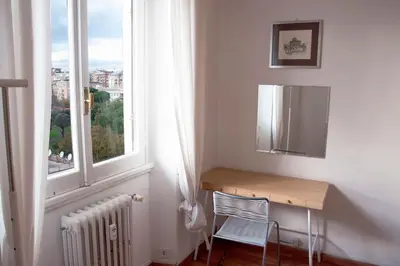 a white room with a desk and a window at Mickey's House in Rome
