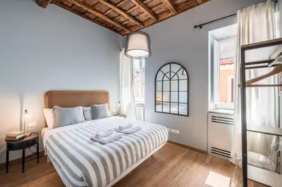 a bedroom with a large bed and a window at La Gatta De Lisa in Rome