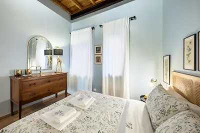 a bedroom with a bed and a dresser and a mirror at La Gatta De Lisa in Rome