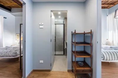 a room with a bed and a room with a ladder at La Gatta De Lisa in Rome