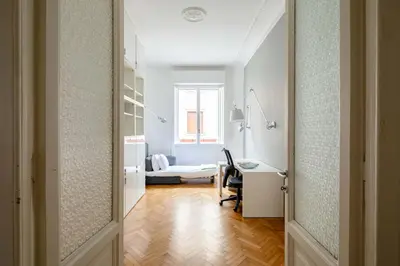 a room with a desk and a bed with a window at Via G. Ferrari Private Apartment in Rome