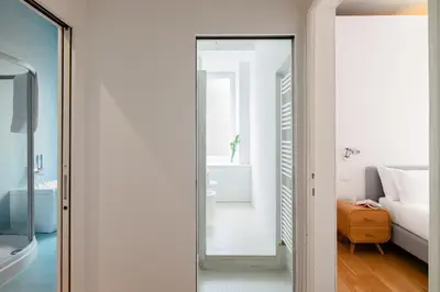 a mirror in a room with a bed and a bathroom at Via G. Ferrari Private Apartment in Rome