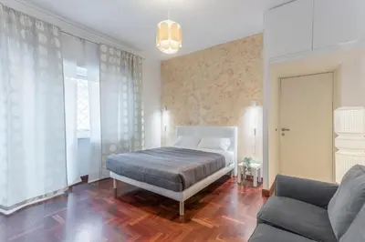 a bedroom with a bed and a couch at Family Art Flat in Rome