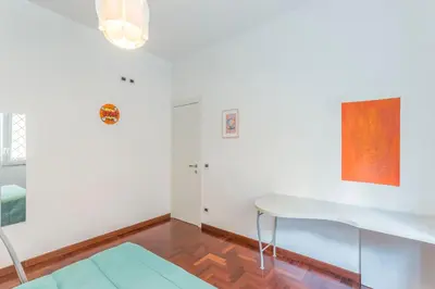 a white room with a desk and a table at Family Art Flat in Rome