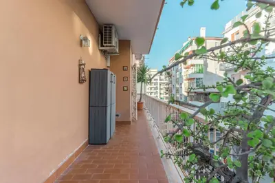 a walkway leading down to a building with buildings at Family Art Flat in Rome