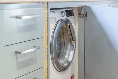 a washer and dryer in a white laundry room at Family Art Flat in Rome