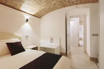 a hotel room with a bed and a desk at Domus Mariani - Cremera by Ghor in Rome
