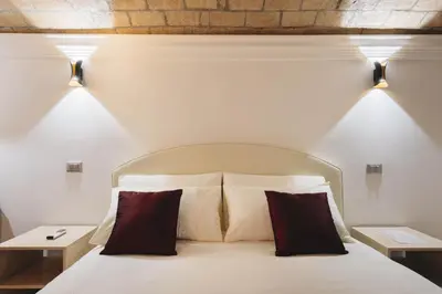 a bedroom with a white bed with two pillows at Domus Mariani - Cremera by Ghor in Rome