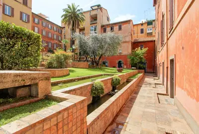 a street in a city with buildings and a canal at Marte in Trevi in Rome