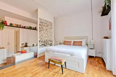 a white bedroom with a white bed and a chair at Marte in Trevi in Rome