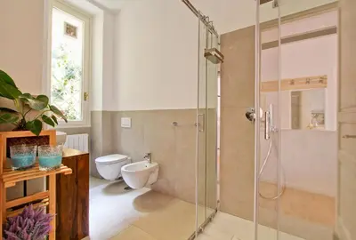 a bathroom with a toilet and a glass shower at Marte in Trevi in Rome