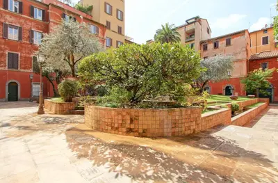 a brick wall with a tree in a courtyard at Marte in Trevi in Rome