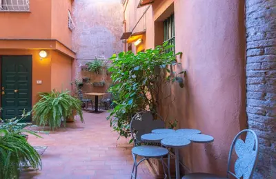 a patio with tables and chairs in a courtyard at Introvabile! Casa Roma centro, Campo de Fiori in Rome