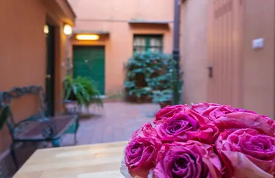 a pink flower sitting on top of a table at Introvabile! Casa Roma centro, Campo de Fiori in Rome