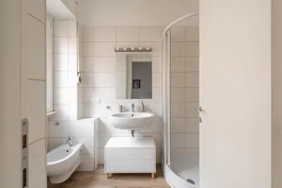 a white bathroom with a sink and a bath tub at LoveRhome Apartment 2 in Rome