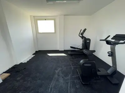 a gym with two exercise bikes and a window at LoveRhome Apartment 2 in Rome