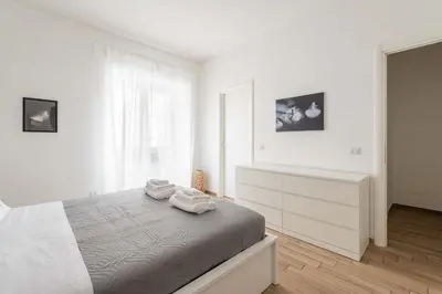 a white bedroom with a bed with towels on it at LoveRhome Apartment 2 in Rome