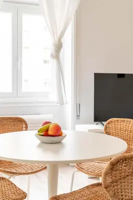 a bowl of fruit sitting on a white table at LoveRhome Apartment 2 in Rome