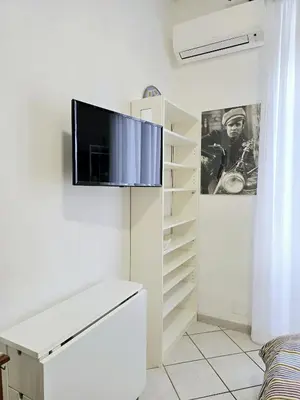 a living room with a tv on a wall at Oasi San Pietro in Rome