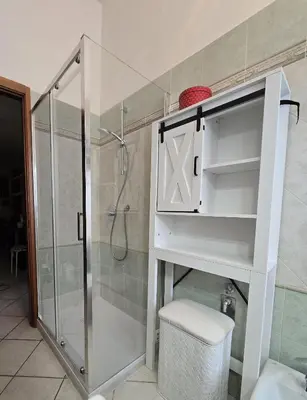 a bathroom with a shower and a toilet and a sink at Oasi San Pietro in Rome