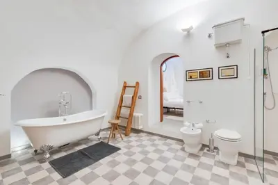 a bathroom with a tub and a toilet and a sink at Fori Imperiali Luxury Apartment in Rome