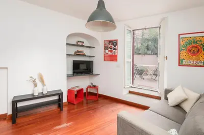 a living room with a couch and a window at Trastevere Zen Home-ZENO 33 in Rome