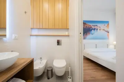 a bathroom with a toilet and a sink at Benny Gold - Elegant apartment right next to the METRO in Rome