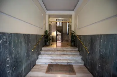 a hallway of a building with stairs and a wall at Benny Gold - Elegant apartment right next to the METRO in Rome