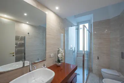 a bathroom with a sink and a toilet and a shower at Benny Gold - Elegant apartment right next to the METRO in Rome