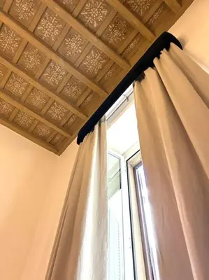 a curtain in a room with a window at The Grand Tour Bed & Breakfast in Rome