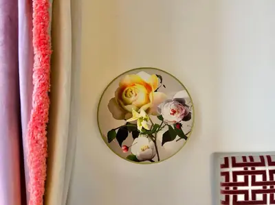 a clock on a wall with flowers on it at The Grand Tour Bed & Breakfast in Rome