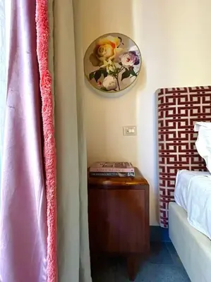 a bedroom with a bed and a clock on the wall at The Grand Tour Bed & Breakfast in Rome
