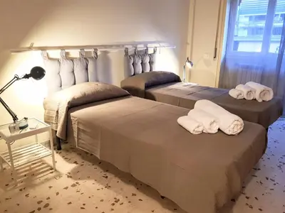 a bedroom with two beds with towels on them at Casa de mi Zia in Rome