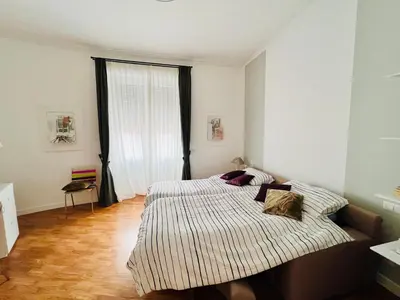 a bedroom with a bed and a large window at Suite21-Parioli in Rome