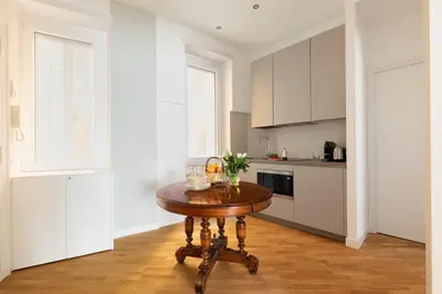 a kitchen with a wooden table in the middle of a room at Suite21-Parioli in Rome