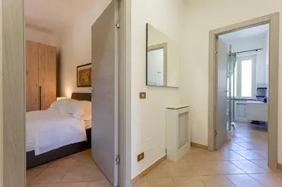 a bedroom with a bed and a mirror at St.Peter station Holiday apartment in Rome