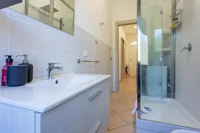 a bathroom with a sink and a shower at St.Peter station Holiday apartment in Rome
