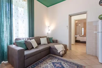 a living room with a couch and a bedroom at St.Peter station Holiday apartment in Rome