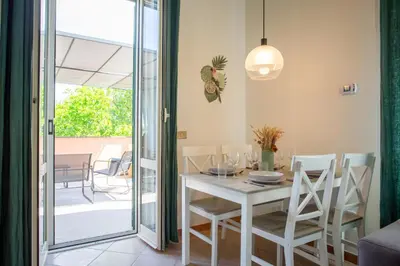 a dining room with a white table and chairs at St.Peter station Holiday apartment in Rome