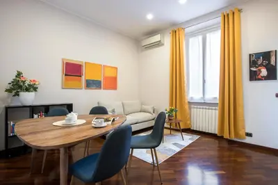 a living room with a table and chairs and a couch at Montebello Style in Rome