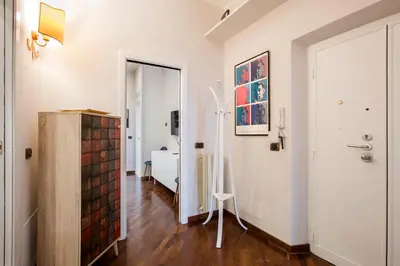 a room with a hallway with white walls and a door at Montebello Style in Rome