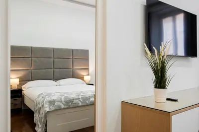 a bedroom with a bed and a mirror on the wall at Montebello Style in Rome