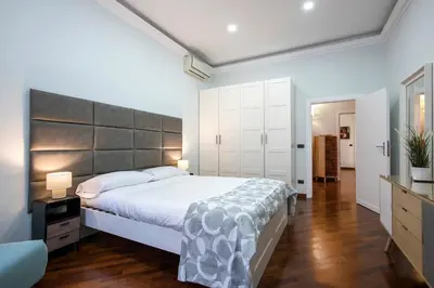 a bedroom with a large bed with a large headboard at Montebello Style in Rome