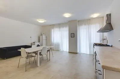 a kitchen and living room with a table and chairs at Guesthouse Vassallo Uno in Rome