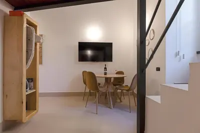 a kitchen and dining room with a table and chairs at Restart Accommodations Colle Oppio e Paganini in Rome